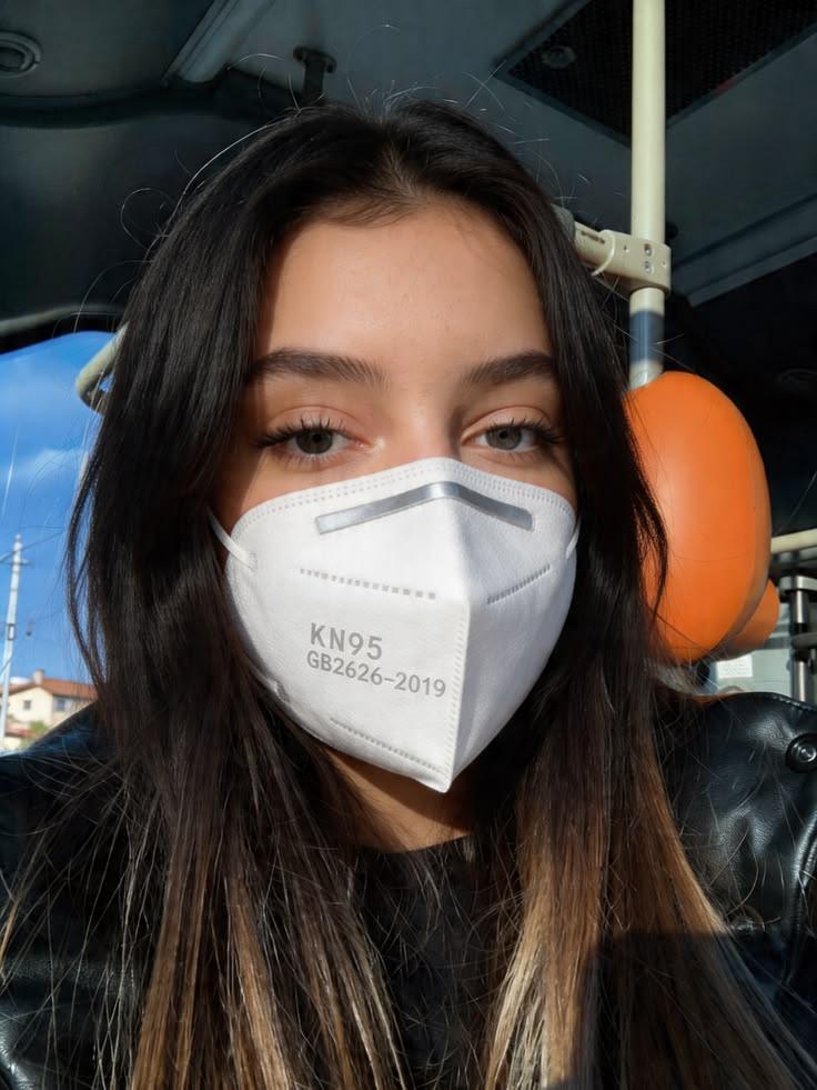 Person wearing a KN95 respirator mask for protection against air pollution